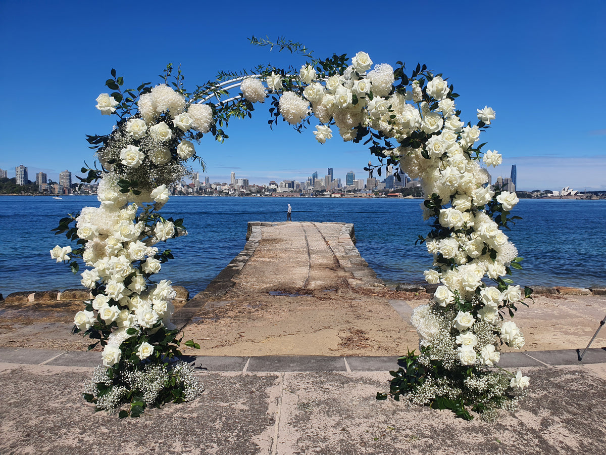 wedding arch in white and green - flower lane & co